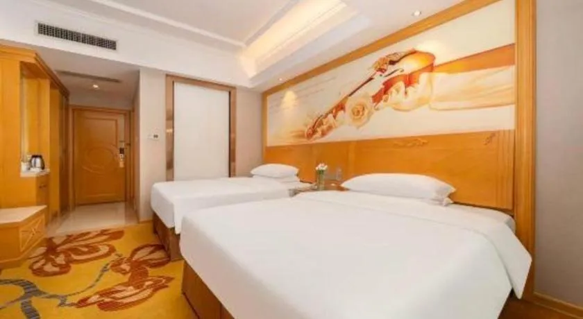 Bed in Vienna Hotel Guangxi Fangcheng