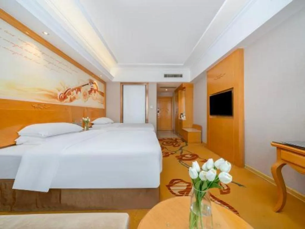 Bed in Vienna Hotel Guangxi Fangcheng