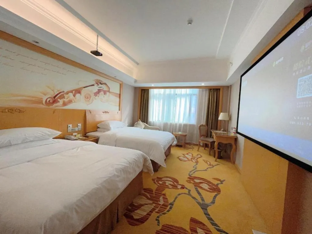 Bed in Vienna Hotel Guangxi Fangcheng