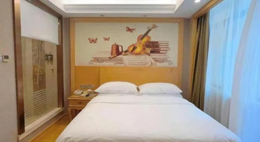 Bed in Vienna Hotel Guangxi Fangcheng