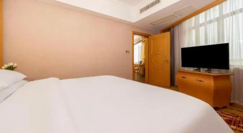 Bed in Vienna Hotel Guangxi Fangcheng