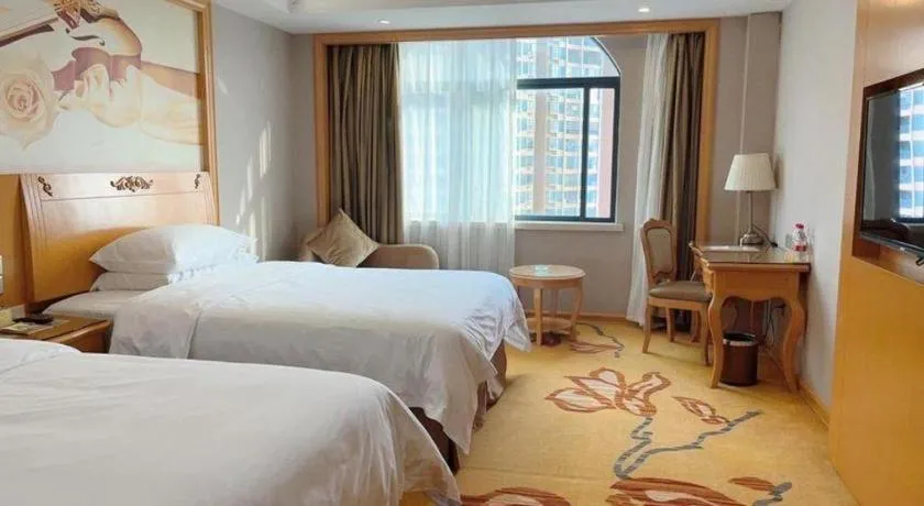 Bed in Vienna Hotel Guangxi Fangcheng