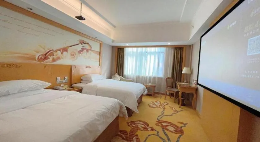 Bed in Vienna Hotel Guangxi Fangcheng