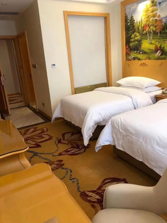 Bed in Vienna Hotel Guangdong Zhaoqing Sihui Tianguangxu