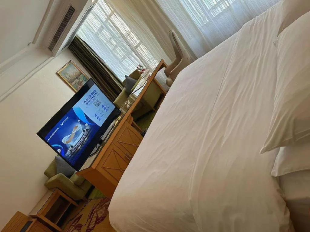 Bed in Vienna Hotel Guangdong Zhaoqing Sihui Tianguangxu