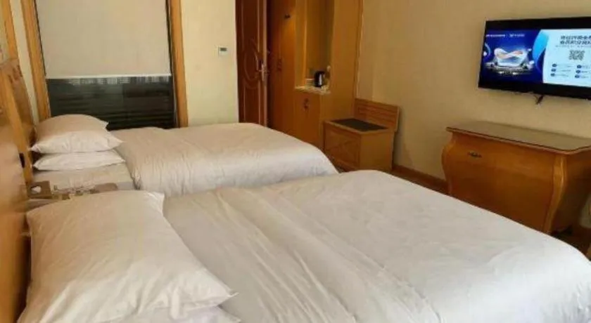 Bed in Vienna Hotel Guangdong Zhaoqing Sihui Tianguangxu