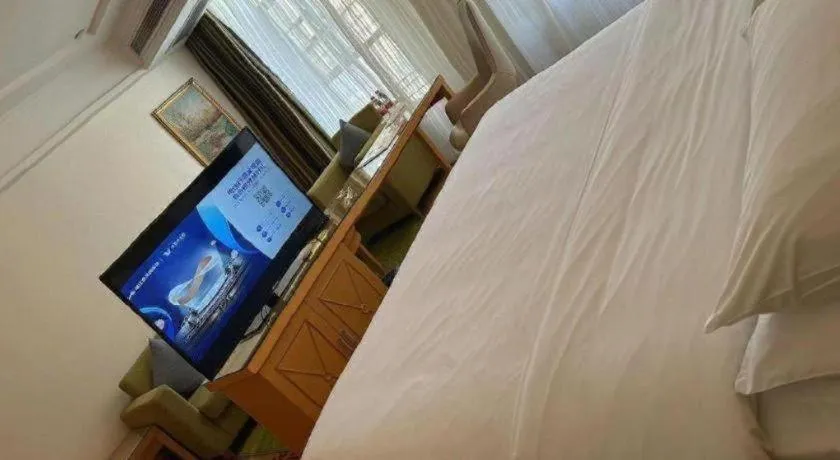 Bed in Vienna Hotel Guangdong Zhaoqing Sihui Tianguangxu