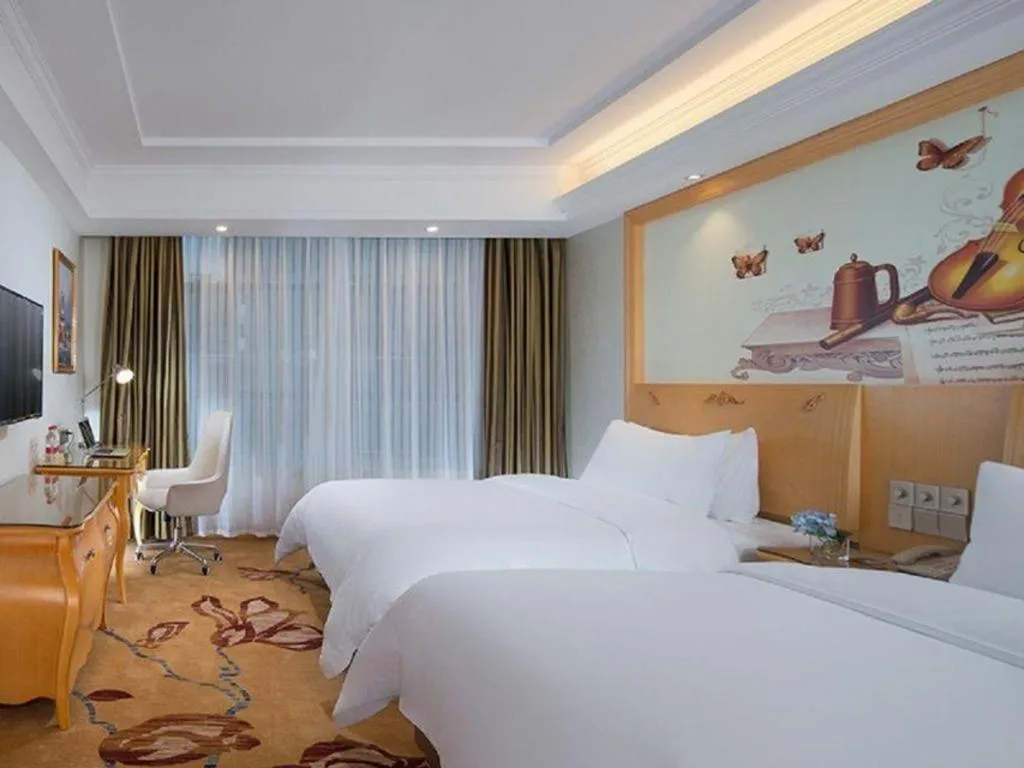 Bed in Vienna Hotel Guangdong Zhaoqing Sihui Tianguangxu