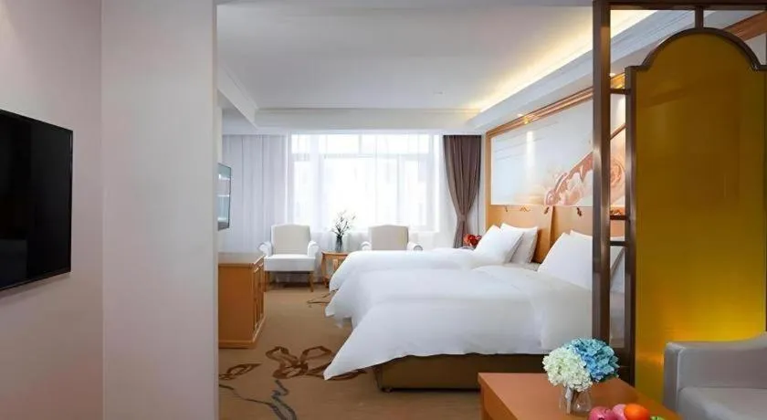 Bed in Vienna Hotel Jilin Dunhua High-Speed Railway Station