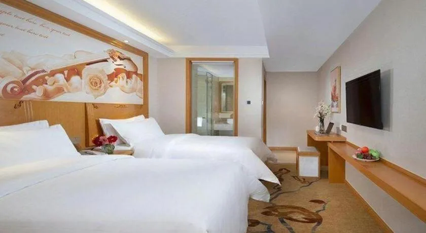 Bed in Vienna Hotel Jilin Dunhua High-Speed Railway Station