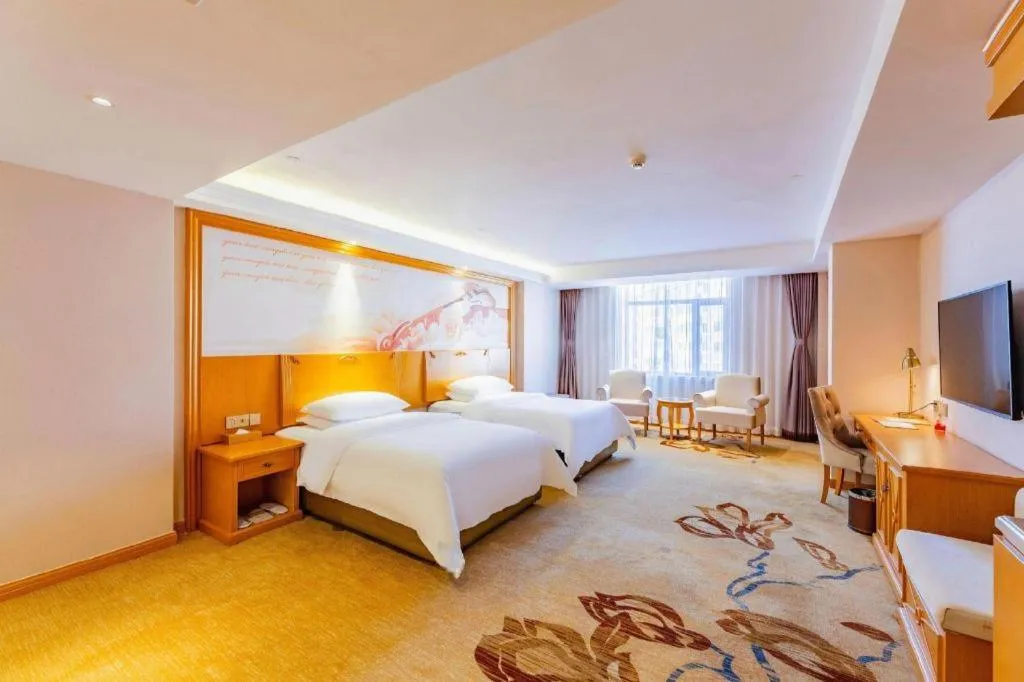 Bed in Vienna Hotel Jilin Dunhua High-Speed Railway Station
