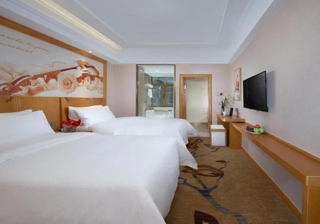 Bed in Vienna Hotel Jilin Dunhua High-Speed Railway Station
