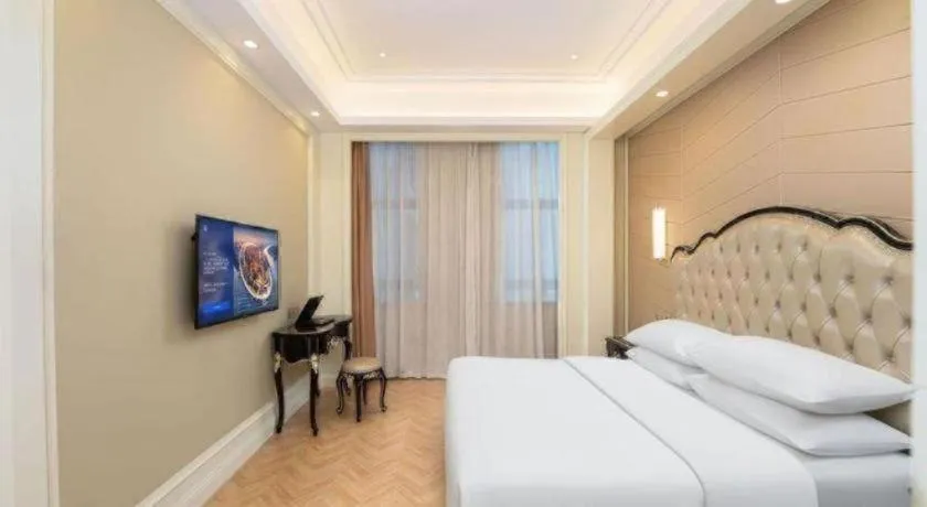 Bed in Vienna Hotel Jiangsu Zhangjiagang Passenger Terminal Station