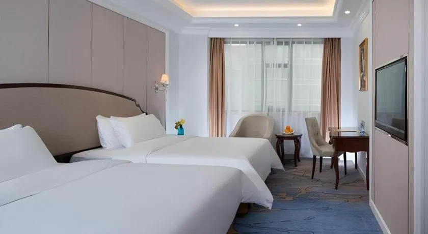 Bed in Vienna Hotel Guangzhou Baiyun College Jinyuan Plaza