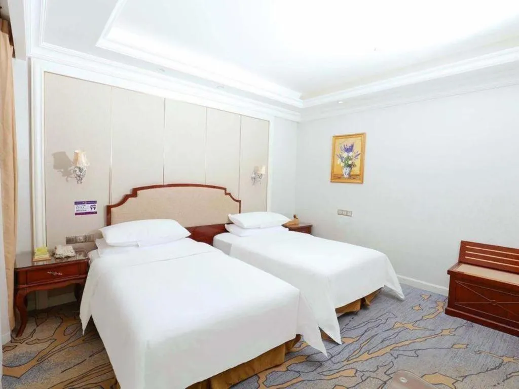 Bed in Vienna Hotel Guangzhou Baiyun College Jinyuan Plaza