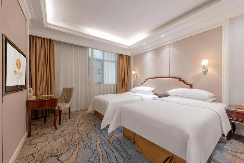 Bed in Vienna Hotel Guangzhou Baiyun College Jinyuan Plaza