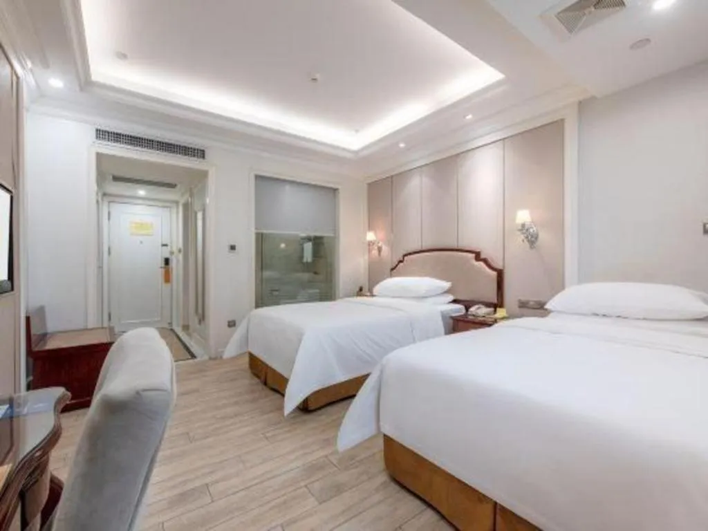 Bed in Vienna Hotel Guangzhou Baiyun College Jinyuan Plaza