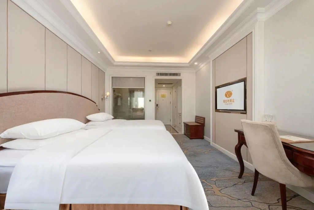 Bed in Vienna Hotel Guangzhou Baiyun College Jinyuan Plaza