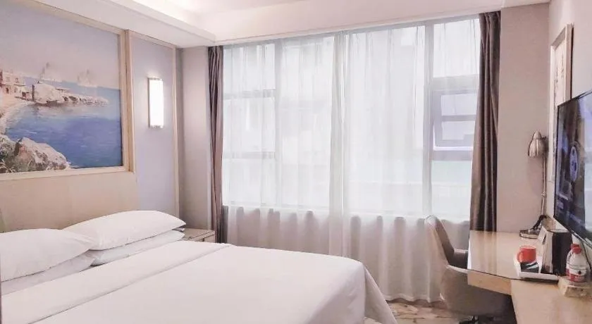 Bed in Vienna Hotel Guangxi Hechi Jinchengjiang Baima Street