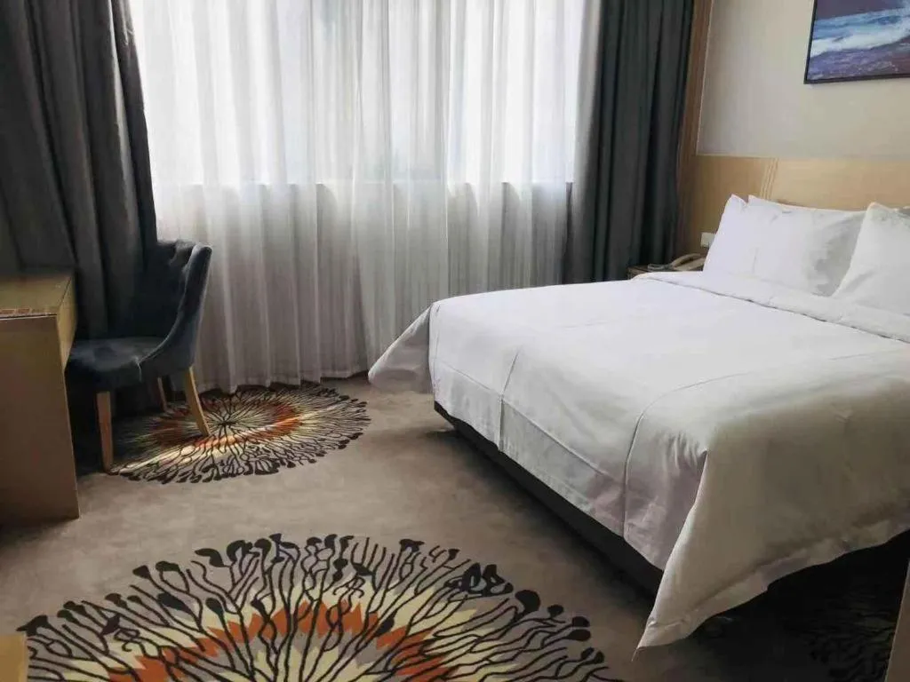 Bed in Vienna Hotel Guangzhou Huadu Financial Center Sunac Amusement Park