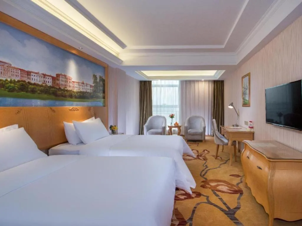 Bed in Vienna Hotel Guangdong Meizhou Fengshun