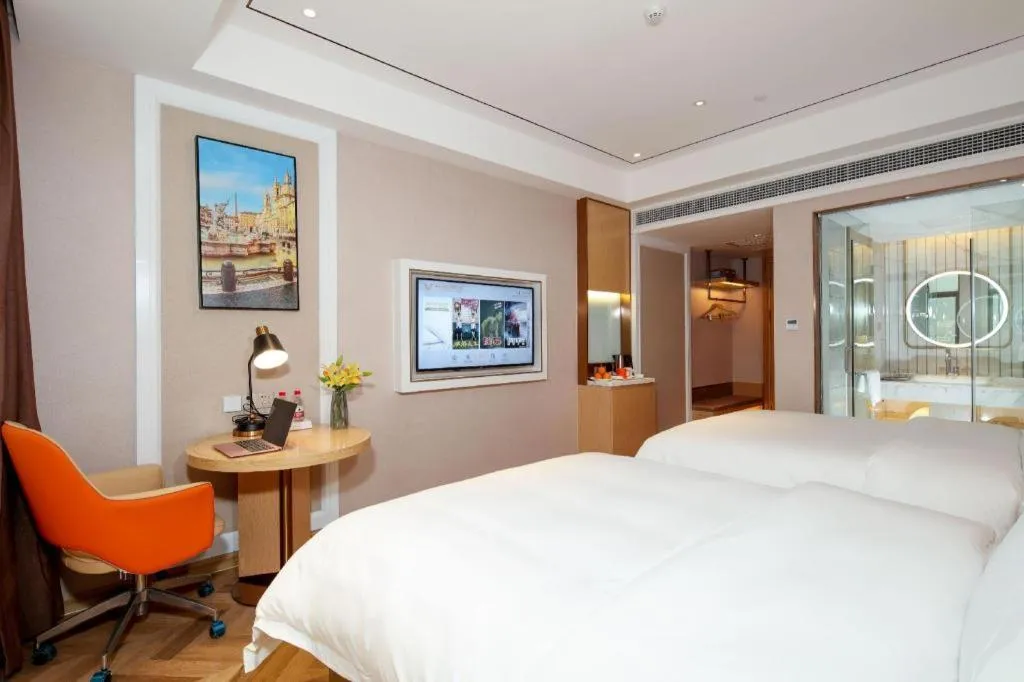 Bed in Vienna Hotel Guangxi Baise Xilin County Juting Cultural Arts Center