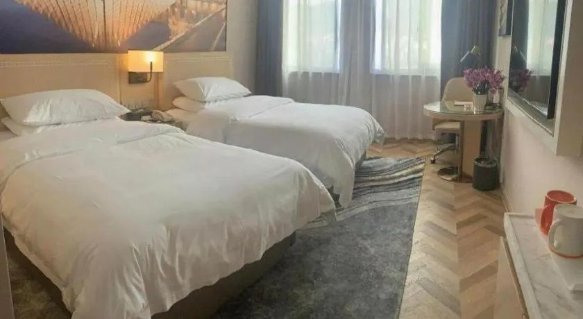 Bed in Vienna Hotel Guangxi Baise Xilin County Juting Cultural Arts Center
