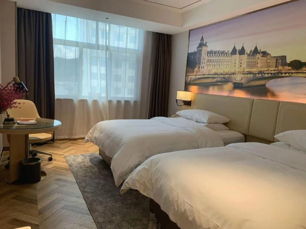 Bed in Vienna Hotel Guangxi Baise Xilin County Juting Cultural Arts Center