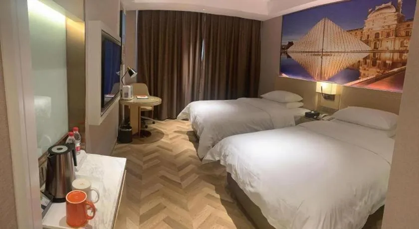 Bed in Vienna Hotel Guangxi Baise Xilin County Juting Cultural Arts Center