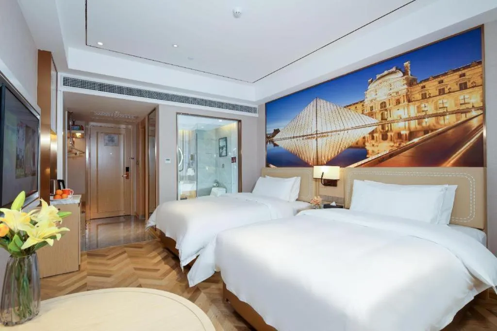 Bed in Vienna Hotel Guangxi Baise Xilin County Juting Cultural Arts Center