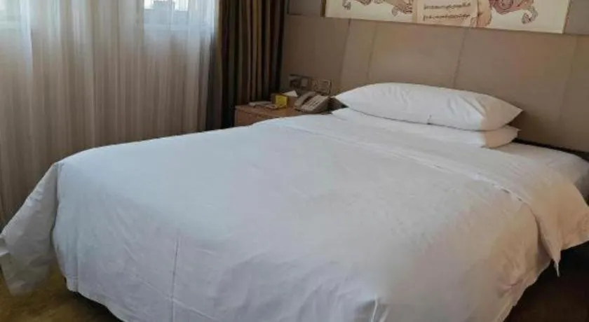 Bed in Vienna Hotel Guangxi Wuzhou High-Tech