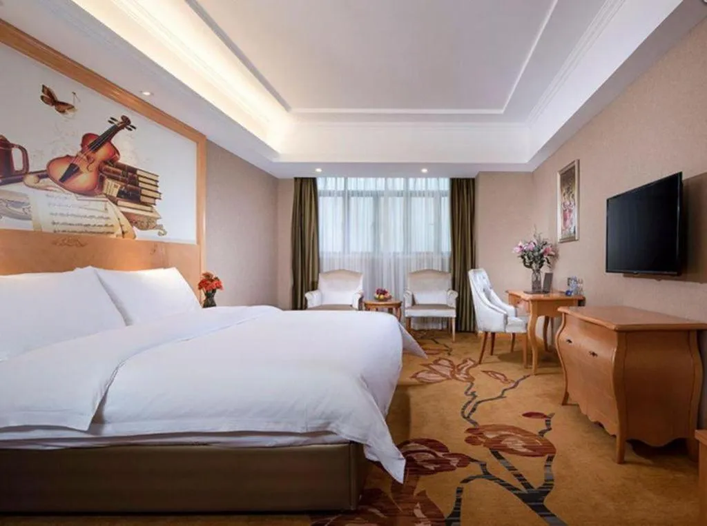 Bed in Vienna Hotel Guangxi Wuzhou High-Tech