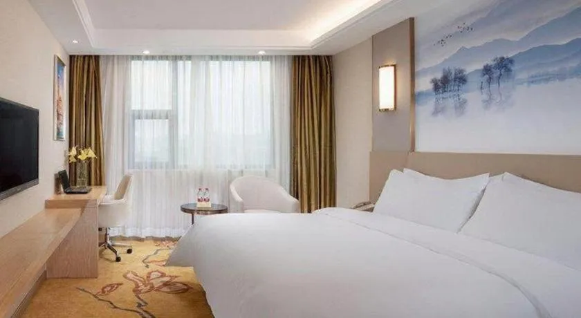 Bed in Vienna Hotel Guangxi Wuzhou High-Tech