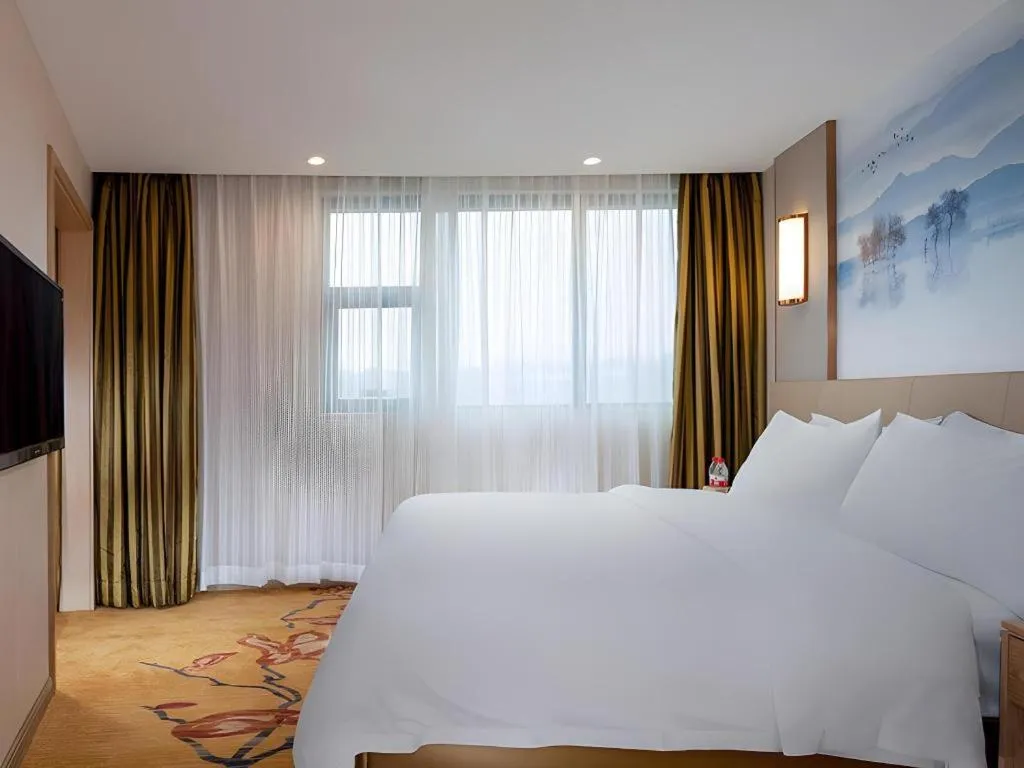 Bed in Vienna Hotel Guangxi Wuzhou High-Tech