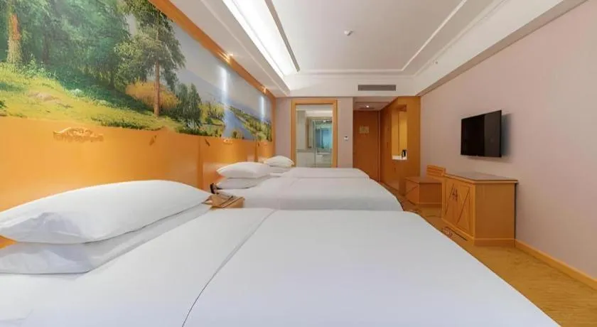 Bed in Vienna Hotel Guangdong Shaoguan Ruyuan Yao Cultural Square