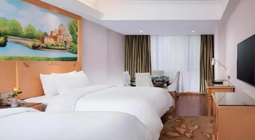 Bed in Vienna Hotel Guangdong Shaoguan Ruyuan Yao Cultural Square