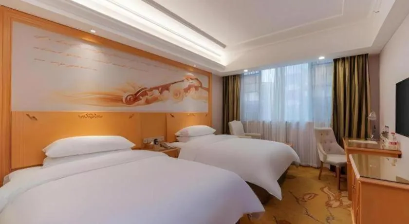 Bed in Vienna Hotel Guangdong Shaoguan Ruyuan Yao Cultural Square