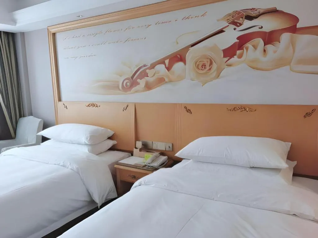 Bed in Vienna Hotel Guangdong Shaoguan Ruyuan Yao Cultural Square