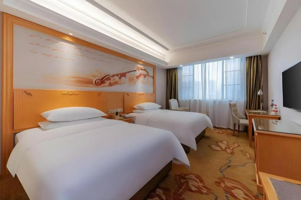 Bed in Vienna Hotel Guangdong Shaoguan Ruyuan Yao Cultural Square