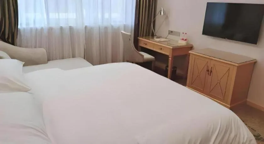 Bed in Vienna Hotel Guangdong Shaoguan Ruyuan Yao Cultural Square