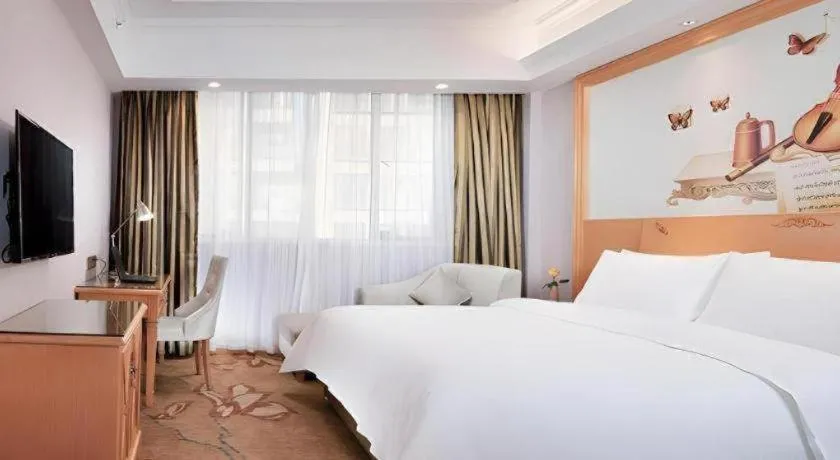 Bed in Vienna Hotel Guangdong Shaoguan Ruyuan Yao Cultural Square