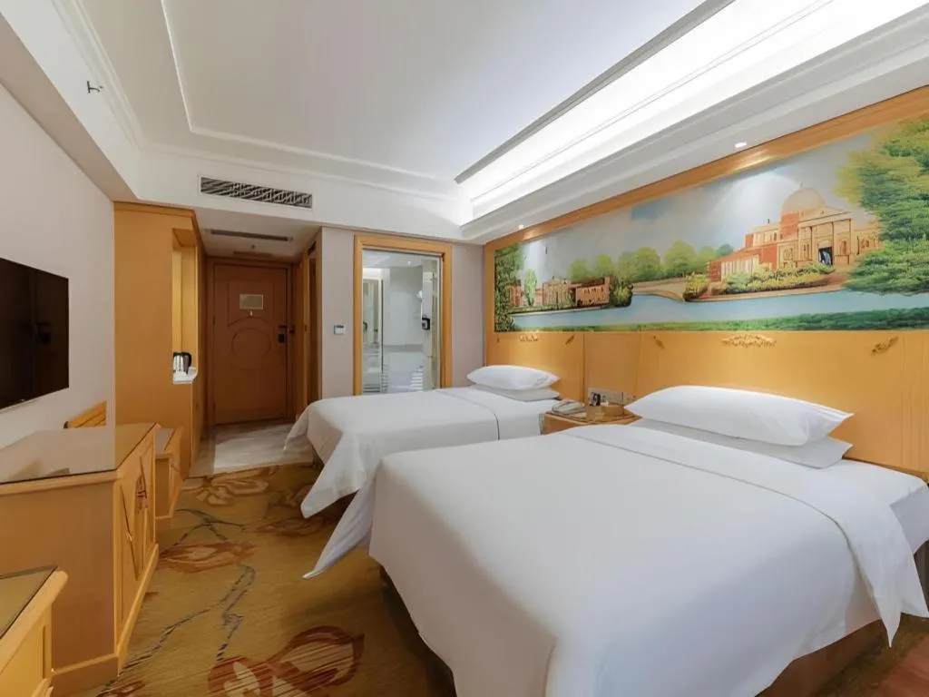 Bed in Vienna Hotel Guangdong Shaoguan Ruyuan Yao Cultural Square