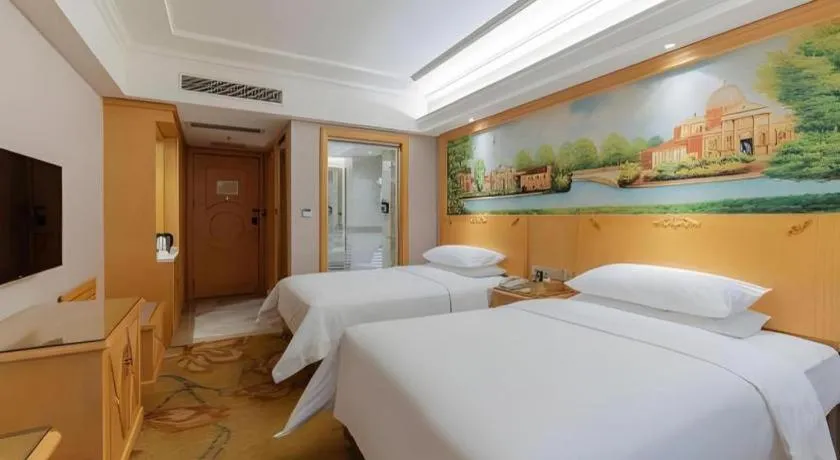 Bed in Vienna Hotel Guangdong Shaoguan Ruyuan Yao Cultural Square