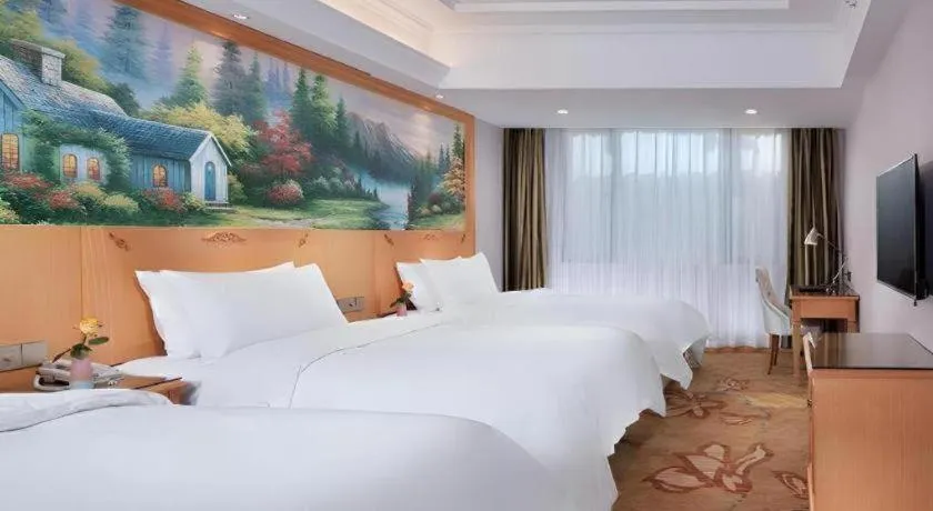 Bed in Vienna Hotel Guangdong Shaoguan Ruyuan Yao Cultural Square