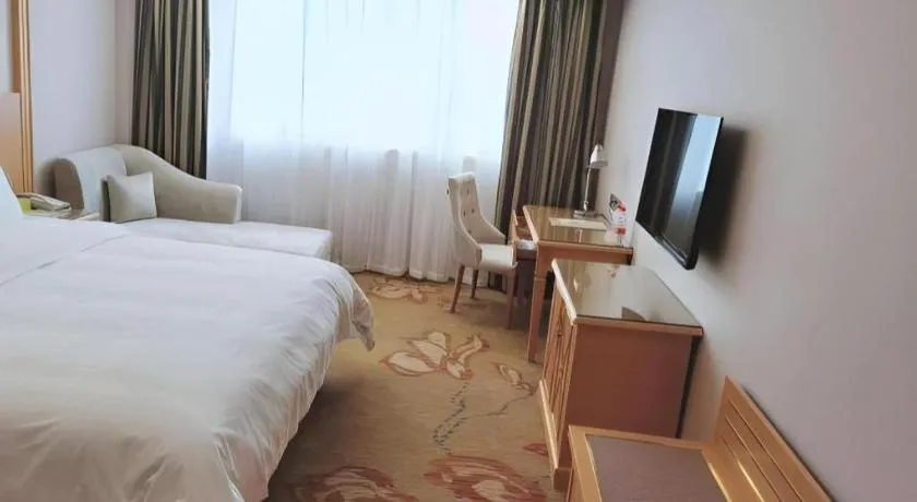 Bed in Vienna Hotel Guangdong Shaoguan Ruyuan Yao Cultural Square