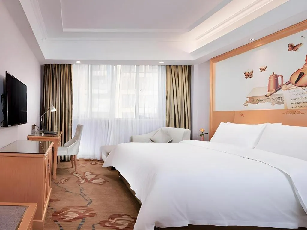 Bed in Vienna Hotel Guangdong Shaoguan Ruyuan Yao Cultural Square