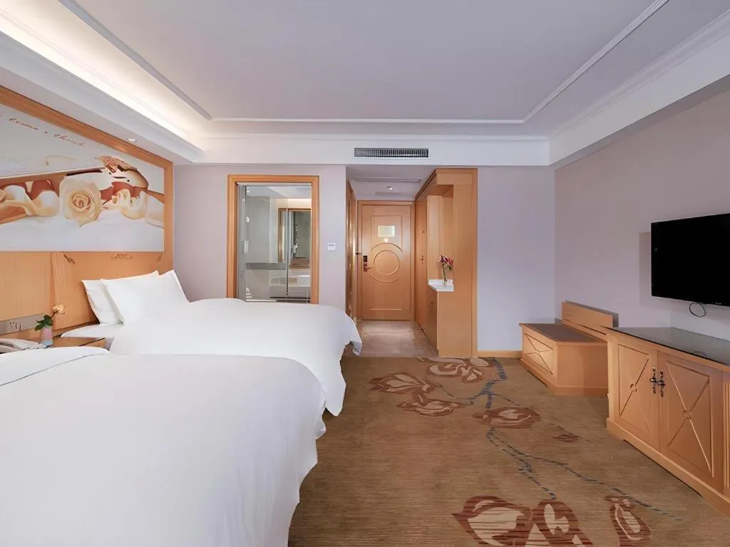 Bed in Vienna Hotel Guangdong Shaoguan Ruyuan Yao Cultural Square