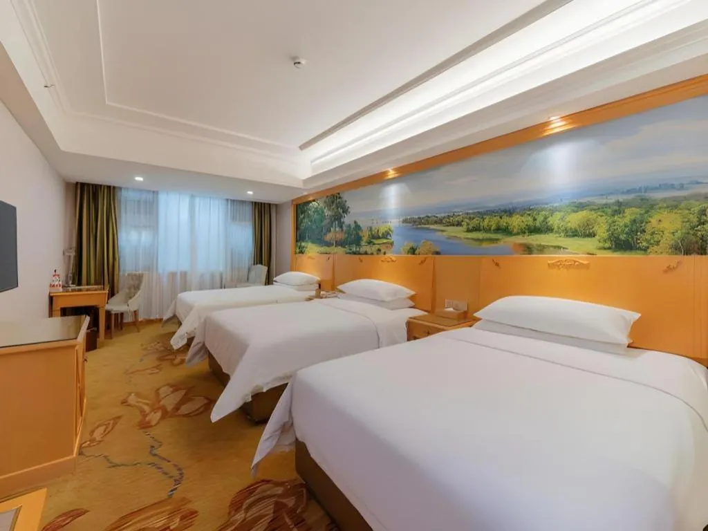 Bed in Vienna Hotel Guangdong Shaoguan Ruyuan Yao Cultural Square