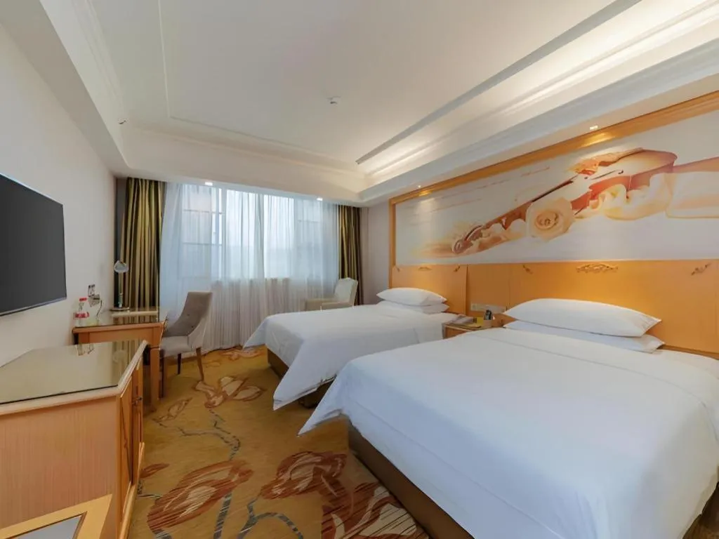 Bed in Vienna Hotel Guangdong Shaoguan Ruyuan Yao Cultural Square