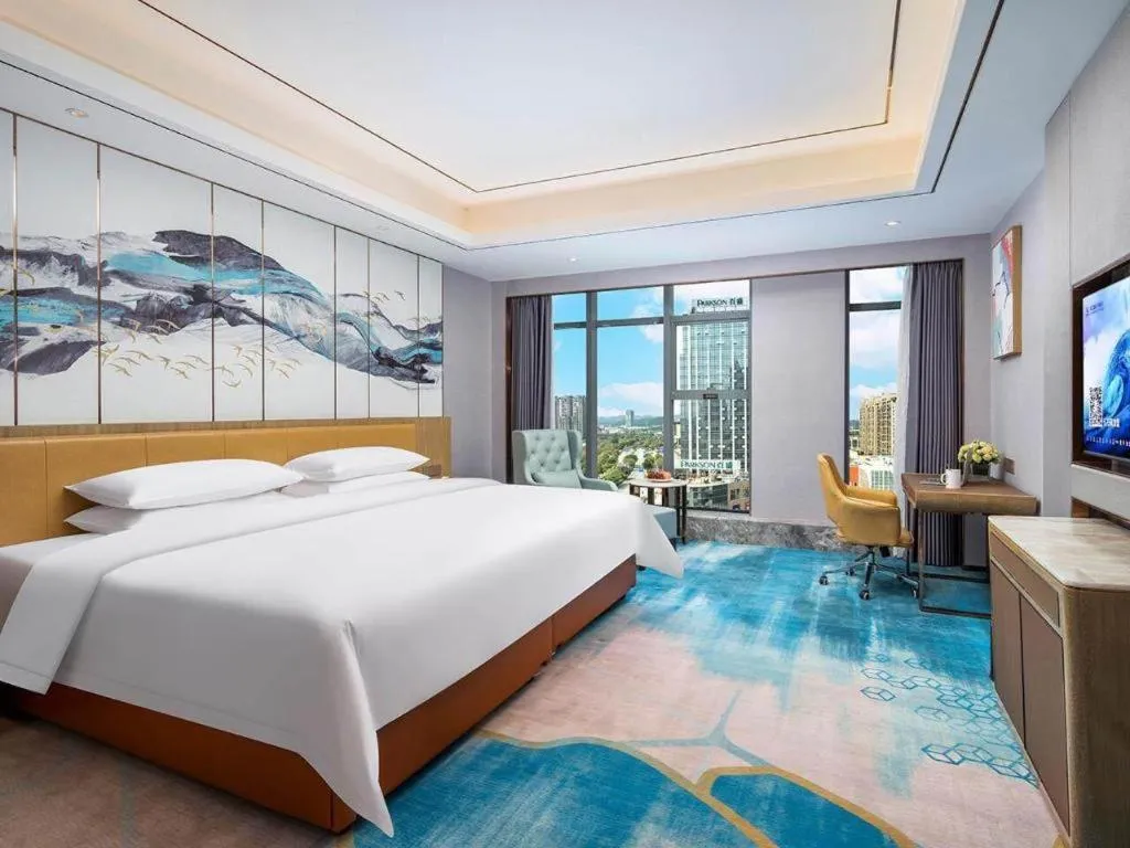 Bed in Venus Royal Hotel Guangxi Wuzhou Sanqicheng Meiguihu Park